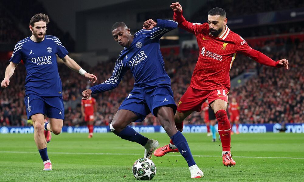 Ousmane Dembélé and Khvicha Kvaratskhelia of PSG battle Mohamed Salah of Liverpool in a Champions League clash at Anfield