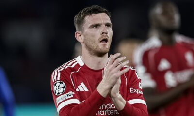 Liverpool defender Andrew Robertson clapping for fans in the 2025/26 home kit during a Champions League match.A photo used by Sportxparte news