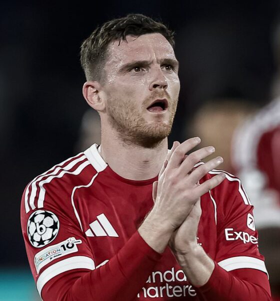 Liverpool defender Andrew Robertson clapping for fans in the 2025/26 home kit during a Champions League match.A photo used by Sportxparte news
