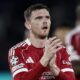 Liverpool defender Andrew Robertson clapping for fans in the 2025/26 home kit during a Champions League match.A photo used by Sportxparte news