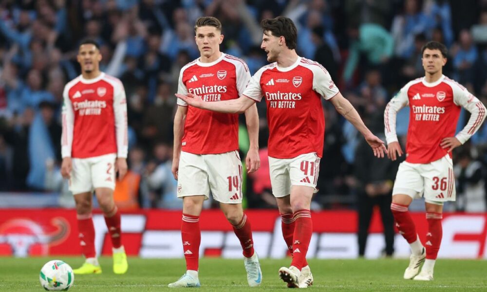 Arsenal stars Declan Rice (41) and new striker Viktor Gyökeres in conversation on the pitch. They are flanked by teammates William Saliba (2), Jurriën Timber (12), and Martín Zubimendi (36) in their 2025/26 red and white home kits.. Image used for Sportxparte news.