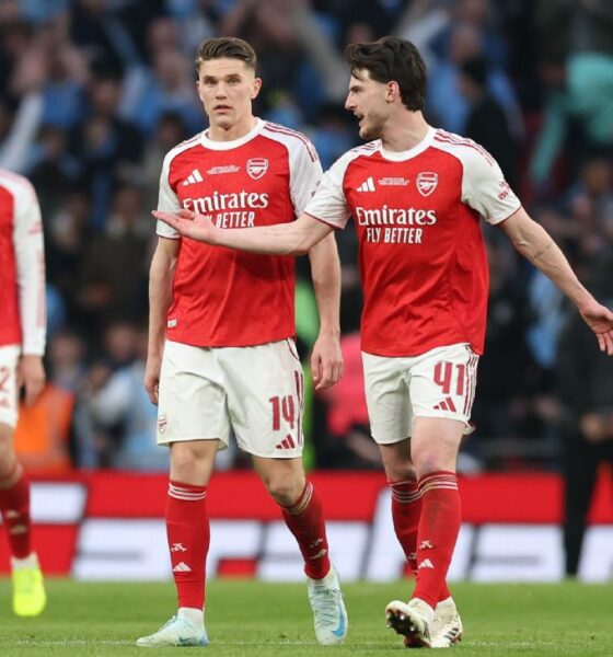 Arsenal stars Declan Rice (41) and new striker Viktor Gyökeres in conversation on the pitch. They are flanked by teammates William Saliba (2), Jurriën Timber (12), and Martín Zubimendi (36) in their 2025/26 red and white home kits.. Image used for Sportxparte news.