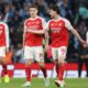 Arsenal stars Declan Rice (41) and new striker Viktor Gyökeres in conversation on the pitch. They are flanked by teammates William Saliba (2), Jurriën Timber (12), and Martín Zubimendi (36) in their 2025/26 red and white home kits.. Image used for Sportxparte news.