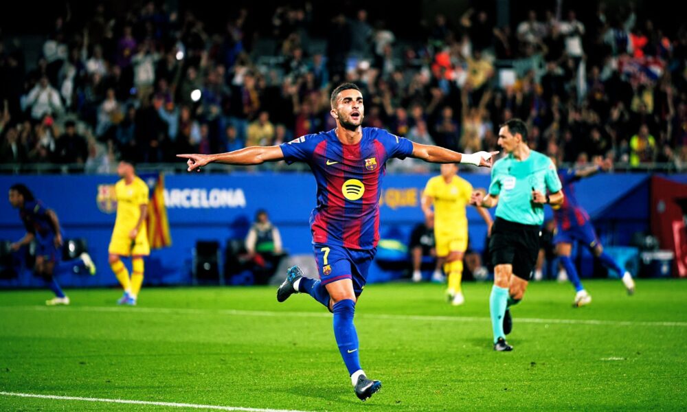 Ferran Torres, celebrates a goal during a match against Getafe. He is running across the green pitch with his arms outstretched and a joyful expression. Image used for Sportxparte news.