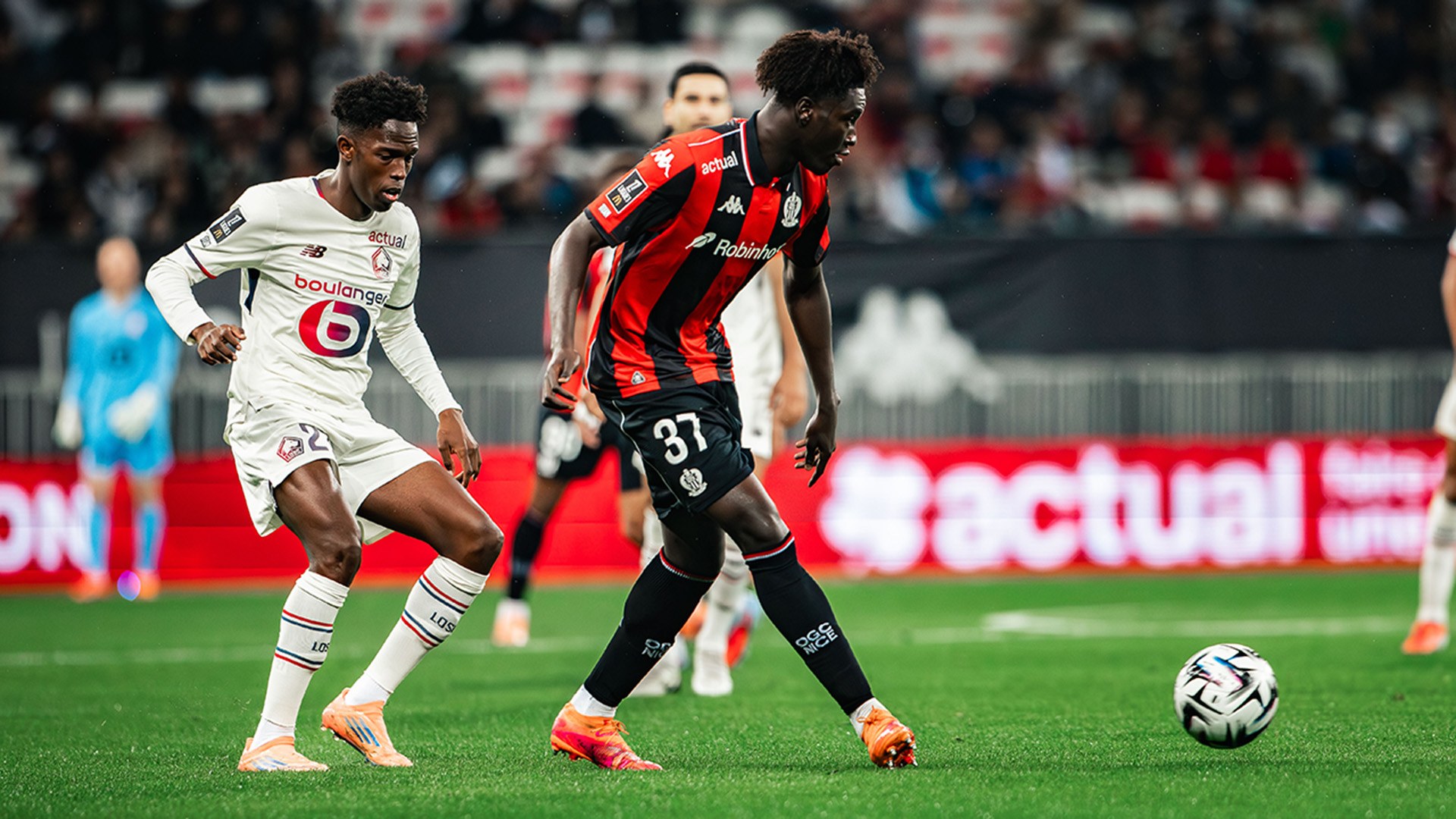 Portuguese defender Tiago Santos of Lille OSC (left, in white) and midfielder Reda Belahyane of OGC Nice (right, in red and black) competing for the ball during a Ligue 1 fixture. Image used for Sportxparte news.