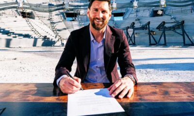 Lionel Messi is signing a new contract with the contract in front of him inside Inter Miami New stadium. Image used for Sportxparte news.