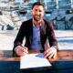 Lionel Messi is signing a new contract with the contract in front of him inside Inter Miami New stadium. Image used for Sportxparte news.