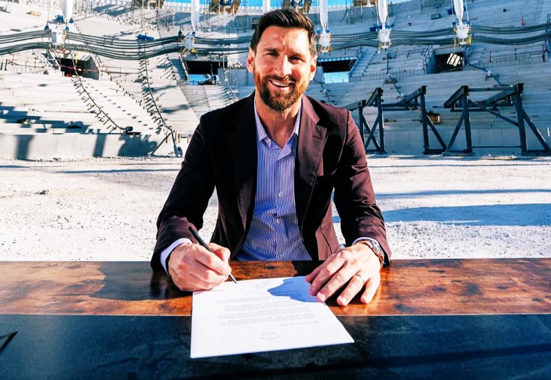 Lionel Messi is signing a new contract with the contract in front of him inside Inter Miami New stadium. Image used for Sportxparte news.