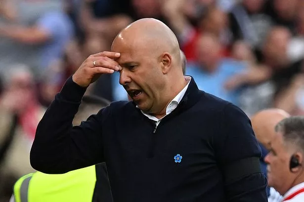 Liverpool Manager Arne Slot is holding his head after a defeat. This image is used by Sportxparte news