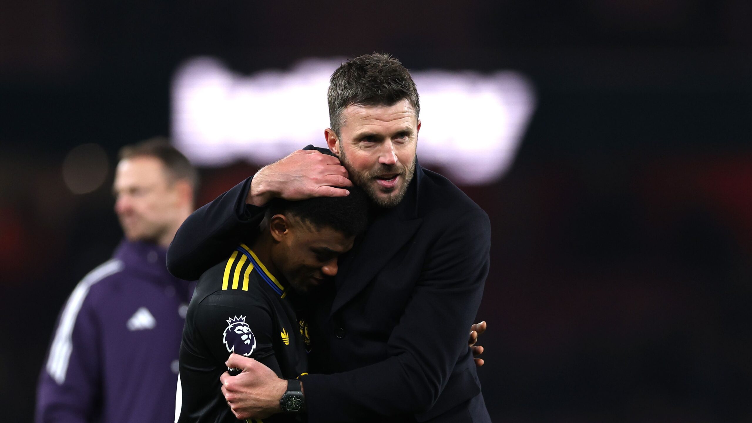 This photo captures a moment between Manchester United coach Michael Carrick and player Amad Diallo following a match. Photo used in sportxparte news coverage.