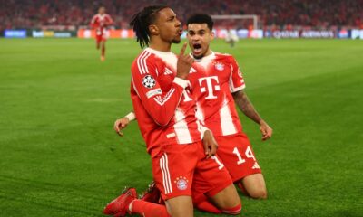 This image captures Michael Olise and Luis Díaz celebrating a late goal during the UEFA Champions League quarter-final second leg between Bayern Munich and Real Madrid on April 15, 2026. Image used for Sportxparte news.