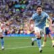 Nico González of Manchester City is celebrating a decisive late goal during a 2-1 victory over Southampton in the FA Cup semi-final. Behind him to the left, teammate John Stones joins in the celebration. Image used for Sportxparte news roundup.