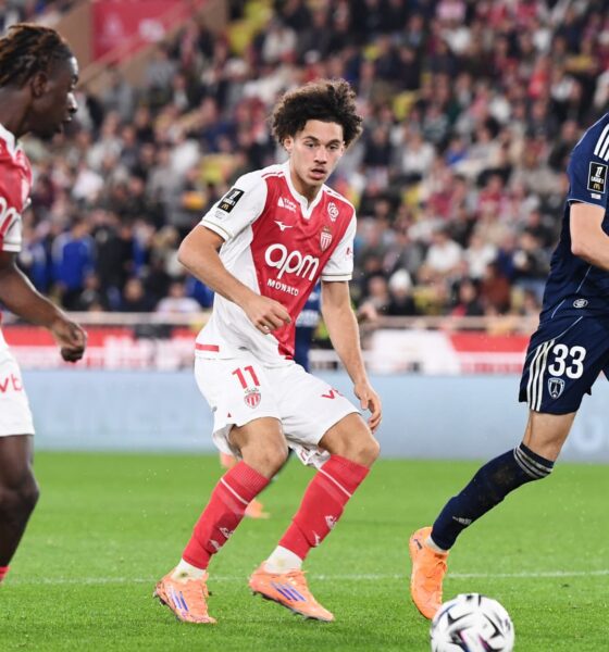 The image captures a Ligue 1 football match between AS Monaco and Paris FC. The featured players include Maghnes Akliouche (center, wearing #11) and George Ilenikhena (left, wearing #28) for AS Monaco, and Pierre Lees-Melou (right, wearing #33) for Paris FC. Image used for Sportxparte news