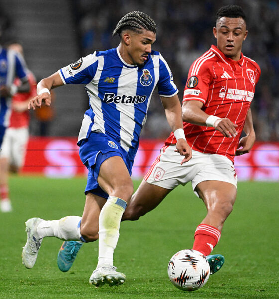 FC Porto winger William Gomes in a blue and white striped kit controls the ball while being pursued by a Nottingham Forest player in a red pinstriped kit during their 2025/26 UEFA Europa League quarterfinal at the Estádio do Dragão. Image used for Sportxparte news.