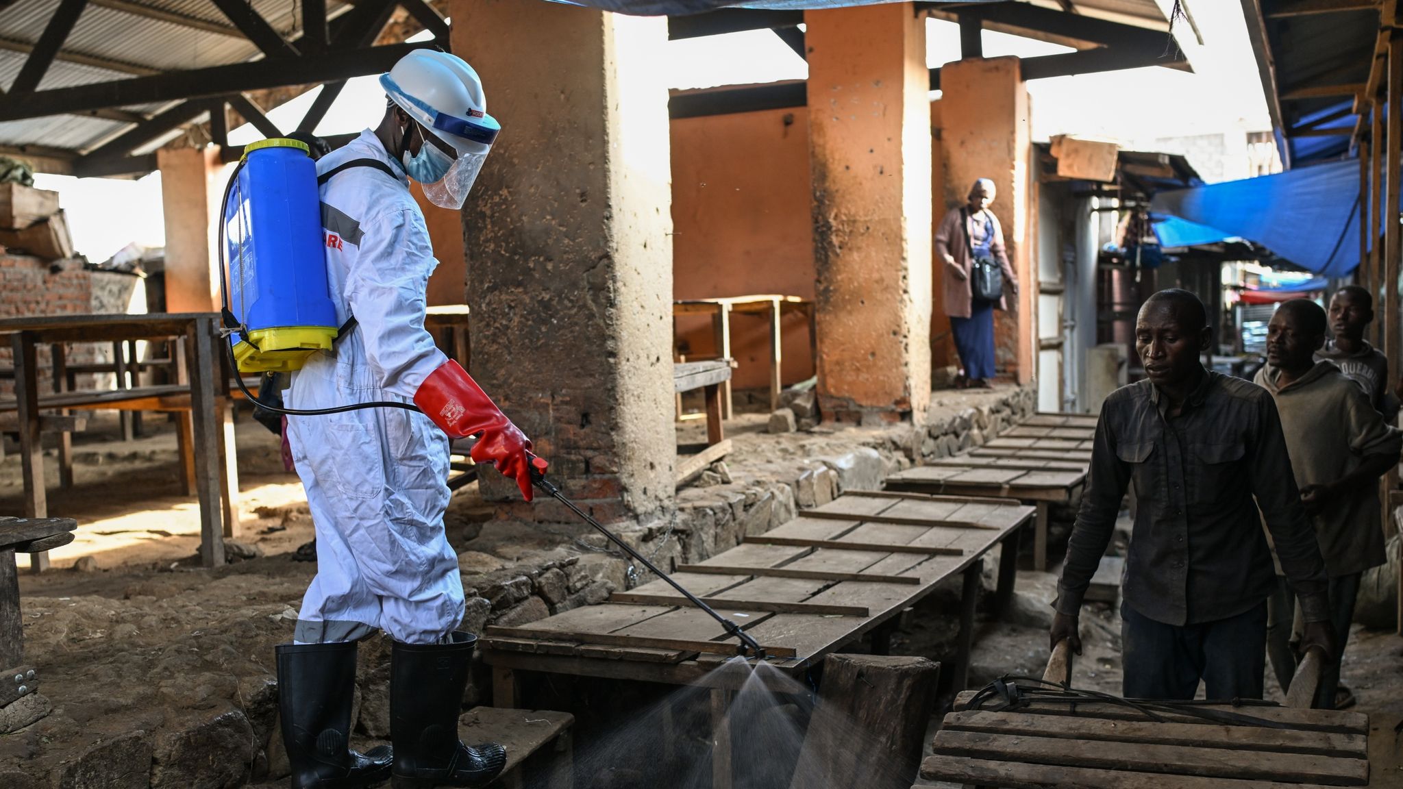 Bunia city government sanitation worker spraying chlorine disinfectant to sanitize the tables at the central public market in Bunia, the capital city of Ituri Province in the eastern Democratic Republic of Congo (DRC). Image used for Sportxparte news.