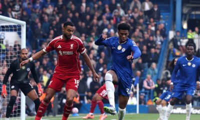 Liverpool forward Cody Gakpo (wearing number 18) and Chelsea defender Josh Acheampong (wearing number 34) during a Premier League match. This specific encounter took place at Stamford Bridge on October 4, 2025, where Chelsea secured a 2-1 victory through a 95th-minute winner by Estevao. Image used for Sportxparte news.