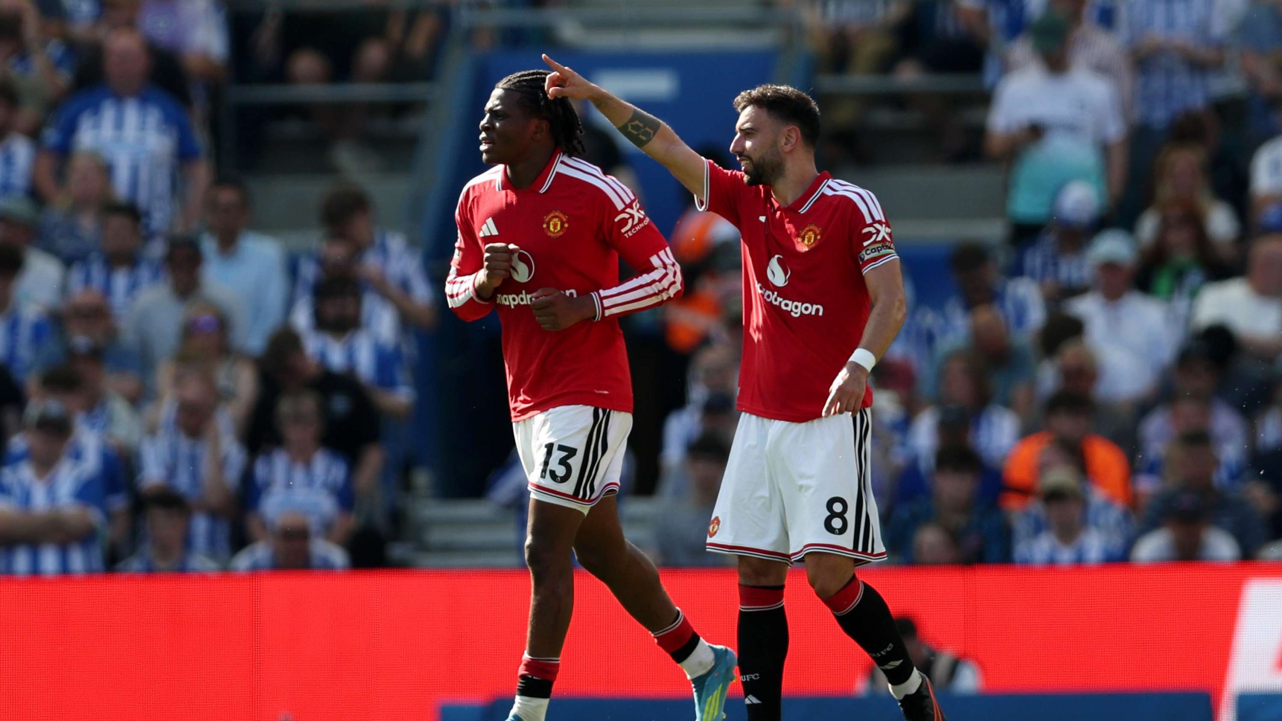 Manchester United players Patrick Dorgu (number 13) and Bruno Fernandes (number 8) celebrate a goal during their final-day Premier League match. Image used for Sportxparte news.