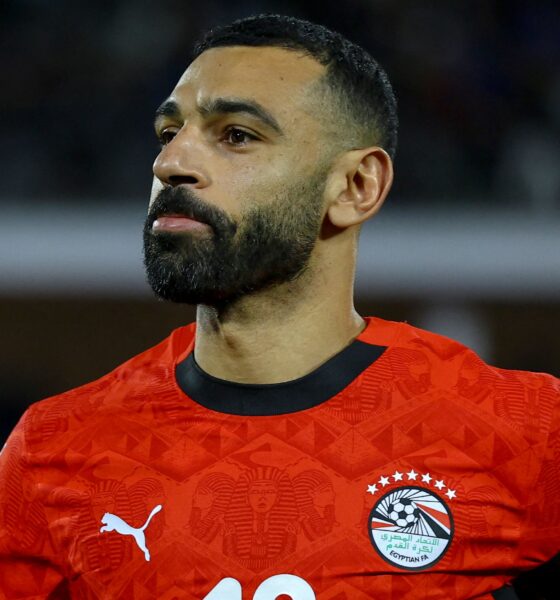 Mohamed Salah representing the Egyptian National Football Team. He is seen sporting a shorter hairstyle and trimmed beard while wearing the official Egyptian red Puma national jersey. Image used for Sportxparte news.