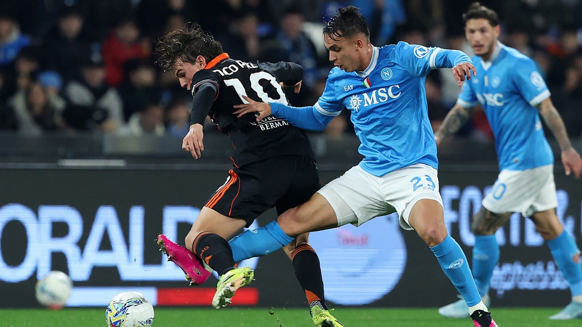 Nico Paz of Como 1907 (wearing black) and Giovane Santana do Nascimento of SSC Napoli (wearing light blue) competing for the ball during a Coppa Italia quarter-final match. Image used for Sportxparte preview news.
