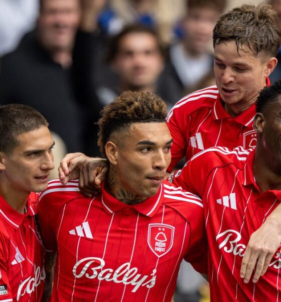 An image of four professional football players from Nottingham Forest celebrating a goal. They are wearing their red home kits with white pinstripes and "Bally's" sponsorship across the chest. From left to right, Nicolas Domínguez, Igor Jesus, James McAtee (background), and Taiwo Awoniyi are huddled together, smiling and embracing in a moment of triumph on the pitch, with a blurred crowd of fans in the background. Image used for Sportxparte news roundup.