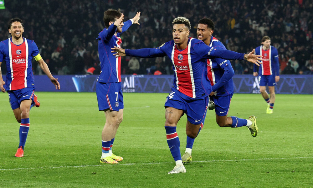 Paris Saint-Germain (PSG) players, including Désiré Doué (centered, arms outstretched) and Ousmane Dembélé (left, in foreground), celebrate a decisive goal during a Ligue 1 match against Stade Brestois 29 on May 10, 2026. Image used for Sportxparte news roundup.