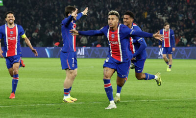 Paris Saint-Germain (PSG) players, including Désiré Doué (centered, arms outstretched) and Ousmane Dembélé (left, in foreground), celebrate a decisive goal during a Ligue 1 match against Stade Brestois 29 on May 10, 2026. Image used for Sportxparte news roundup.