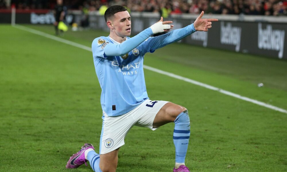 Manchester City's Phil Foden performing his signature "sniper" celebration after scoring during a match against Brentford FC on February 5, 2024. In that specific game, Foden scored a brilliant hat-trick to lead his team to a 3-1 comeback victory. Image used for Sportxparte news.
