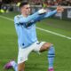 Manchester City's Phil Foden performing his signature "sniper" celebration after scoring during a match against Brentford FC on February 5, 2024. In that specific game, Foden scored a brilliant hat-trick to lead his team to a 3-1 comeback victory. Image used for Sportxparte news.