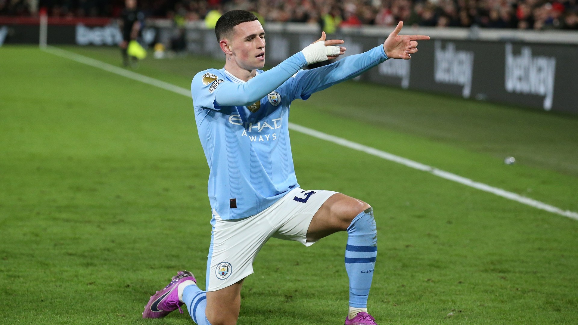 Manchester City's Phil Foden performing his signature "sniper" celebration after scoring during a match against Brentford FC on February 5, 2024. In that specific game, Foden scored a brilliant hat-trick to lead his team to a 3-1 comeback victory. Image used for Sportxparte news.