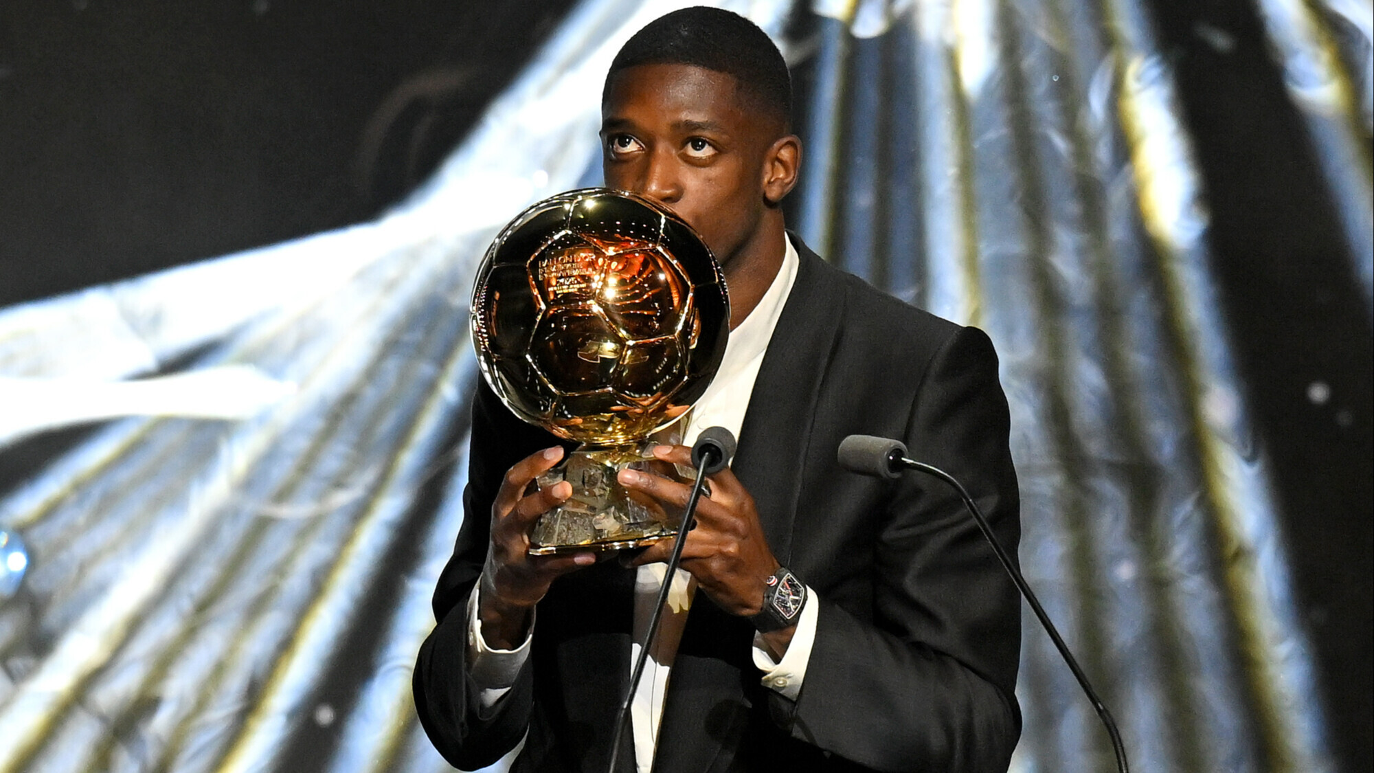 French forward Ousmane Dembélé kissing the Ballon d'Or trophy at the Théâtre du Châtelet in Paris. Image used for Sportxparte news. 