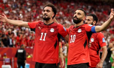 Egypt national football team players Mostafa Mohamed (11) and Mohamed Salah (10) celebrate a goal during a 2026 FIFA World Cup match against New Zealand. Image used for Sportxparte news.