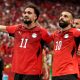 Egypt national football team players Mostafa Mohamed (11) and Mohamed Salah (10) celebrate a goal during a 2026 FIFA World Cup match against New Zealand. Image used for Sportxparte news.