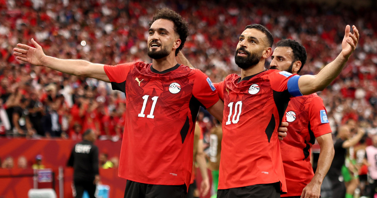 Egypt national football team players Mostafa Mohamed (11) and Mohamed Salah (10) celebrate a goal during a 2026 FIFA World Cup match against New Zealand. Image used for Sportxparte news.