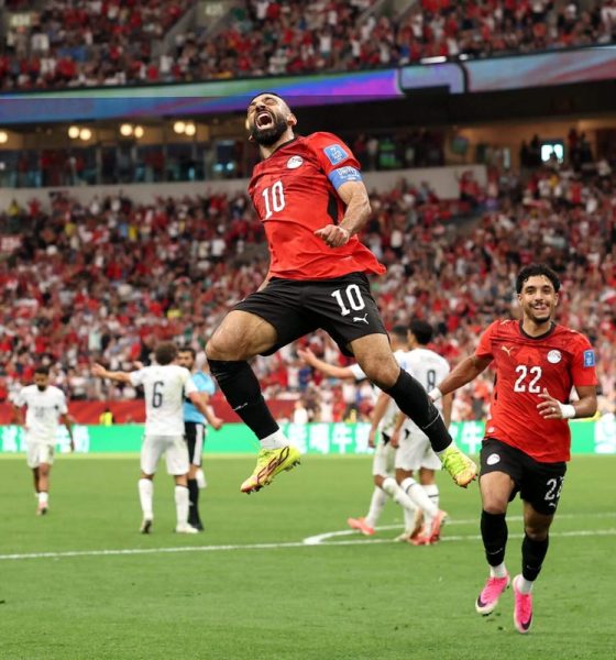 Egypt's Mohamed Salah leaps high into the air in a mid-air celebration alongside teammate Omar Marmoush after scoring against New Zealand during the 2026 FIFA World Cup. Image used for Sportxparte news.