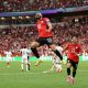 Egypt's Mohamed Salah leaps high into the air in a mid-air celebration alongside teammate Omar Marmoush after scoring against New Zealand during the 2026 FIFA World Cup. Image used for Sportxparte news.