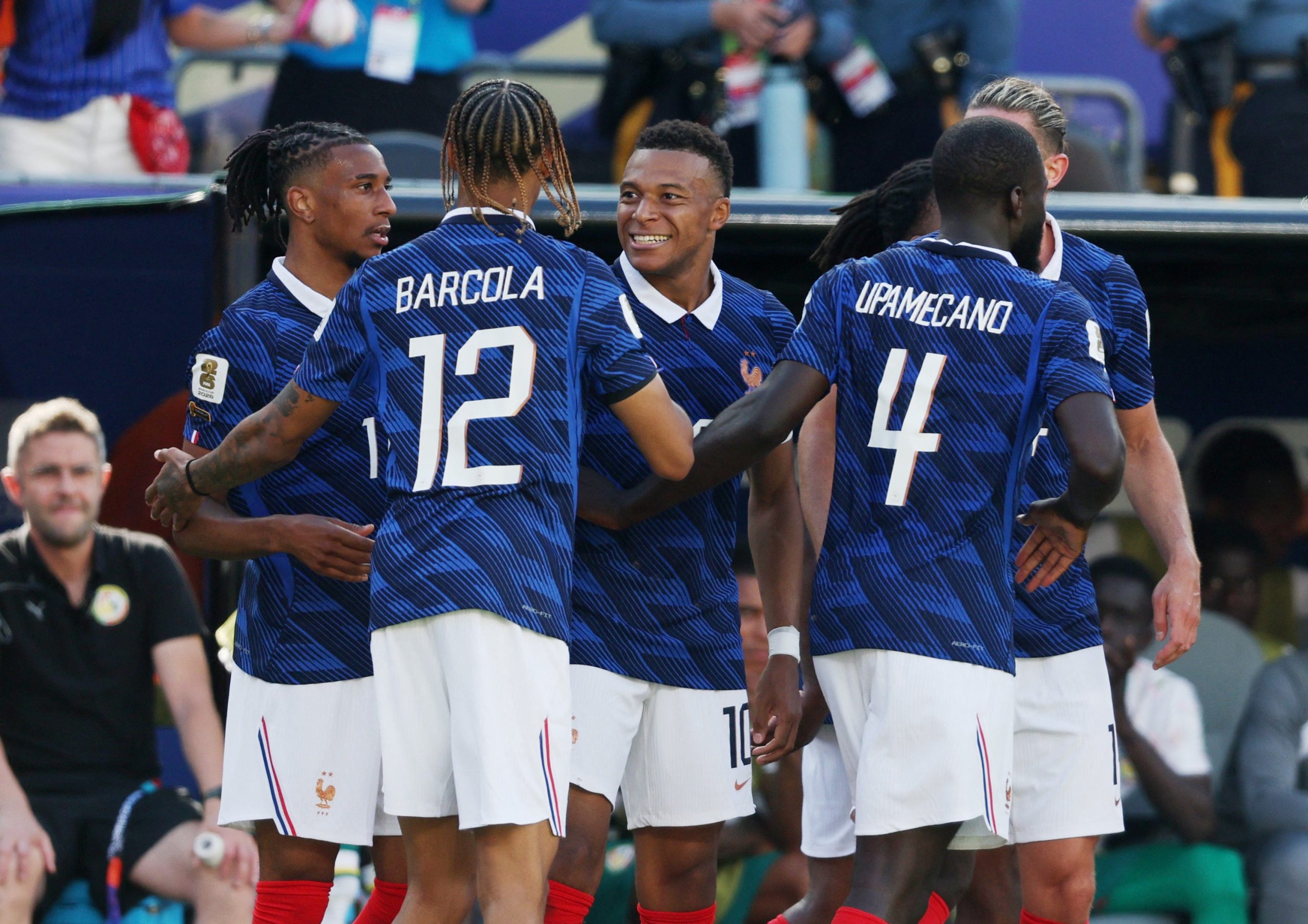 French football players Kylian Mbappe, Bradley Barcola, and Dayot Upamecano celebrate a goal during France vs Senegal at the 2026 FIFA World Cup. Image used for Sportxparte news