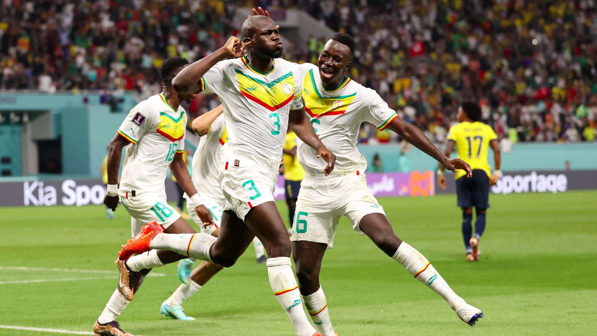 Kalidou Koulibaly (#3) and Nampalys Mendy (#6) celebrate during Senegal's iconic 2-1 victory over Ecuador at the 2022 FIFA World Cup. Koulibaly, serving as the team's captain, scored the decisive match-winning goal in the 70th minute. This crucial win successfully advanced the Lions of Teranga to the Round of 16 for the first time since their legendary debut in 2002. Image used for Sportxparte news.