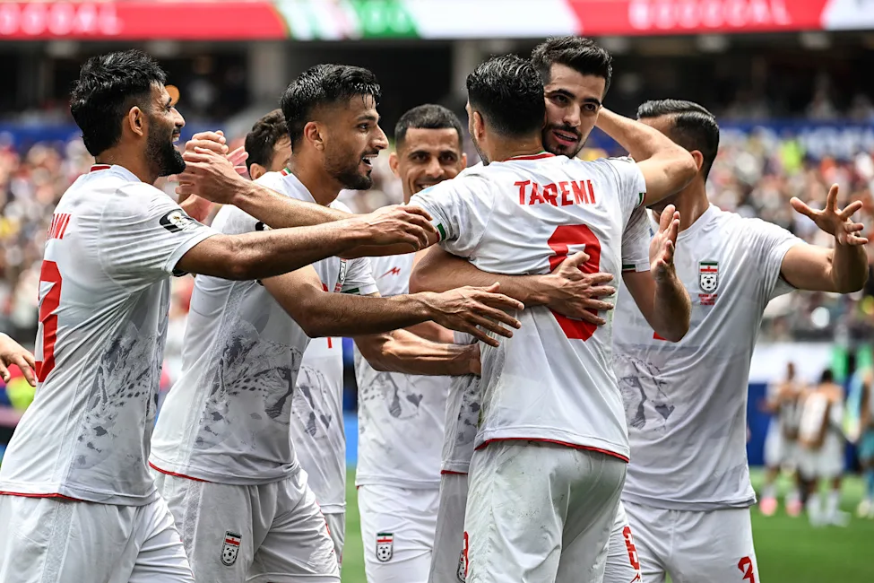 Iran national football team (Team Melli), including striker Mehdi Taremi (wearing jersey number 9), is celebrating a moment during a FIFA World Cup 2026 Group G fixture. Image used for Sportxparte news.