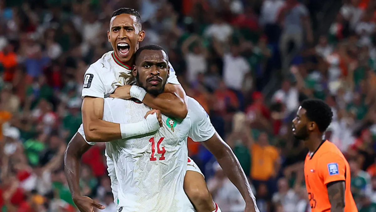 Moroccan defender Issa Diop (wearing number 14) is celebrating with teammate Soufiane Rahimi (wearing number 9) after scoring a dramatic 90+1' minute equalizer against the Netherlands. Image used for Sportxparte news.