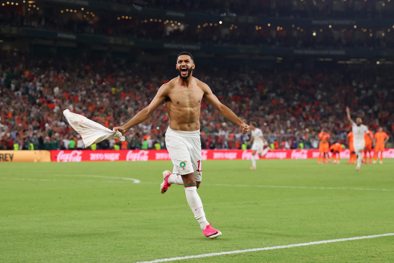 Moroccan winger Ismael Saibari is celebrating shirtless after scoring the winning penalty against the Netherlands at the 2026 FIFA World Cup. Image used for Sportxparte news.