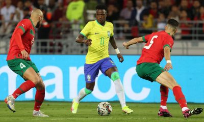 Vinícius Júnior, wearing the number 11 yellow jersey for Brazil, is captured here during an international friendly against Morocco. The match took place on March 25, 2023, at the Ibn Batouta Stadium in Tangier, Morocco. Image used for Sportxparte news.