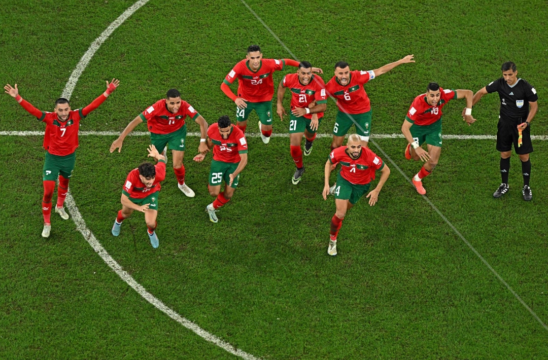 Morocco's national football team made historic waves by becoming the first African and Arab nation to ever reach a World Cup semifinal. This unforgettable moment captured in the image shows the ecstatic team celebrating immediately after winning their dramatic penalty shootout against Spain (3-0) in the Round of 16 during the 2022 FIFA World Cup in Qatar. Image used for Sportxparte news.