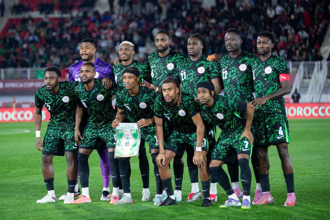 Nigeria's national football team, the Super Eagles starting lineup posing in green jerseys at the AFCON tournament. Image used for Sportxparte news. 