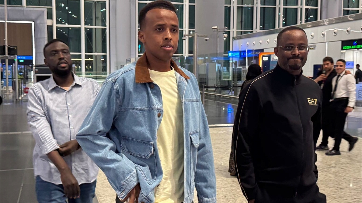 This image shows Somali international football referee Omar Abdulkadir Artan at Istanbul Airport after he was denied entry into the United States to officiate at the 2026 FIFA World Cup. 