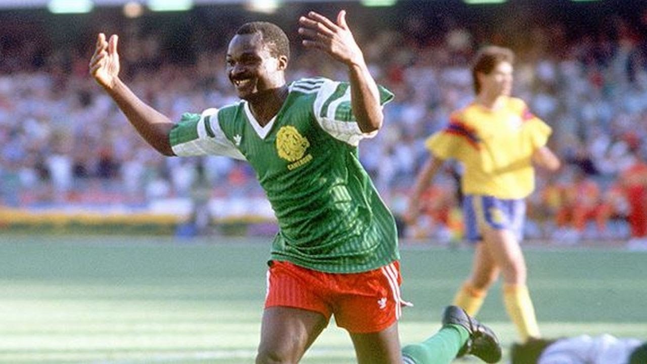 Roger Milla celebrating a goal at the 1990 FIFA World Cup, known for his iconic dancing celebration. Image used for Sportxparte news.