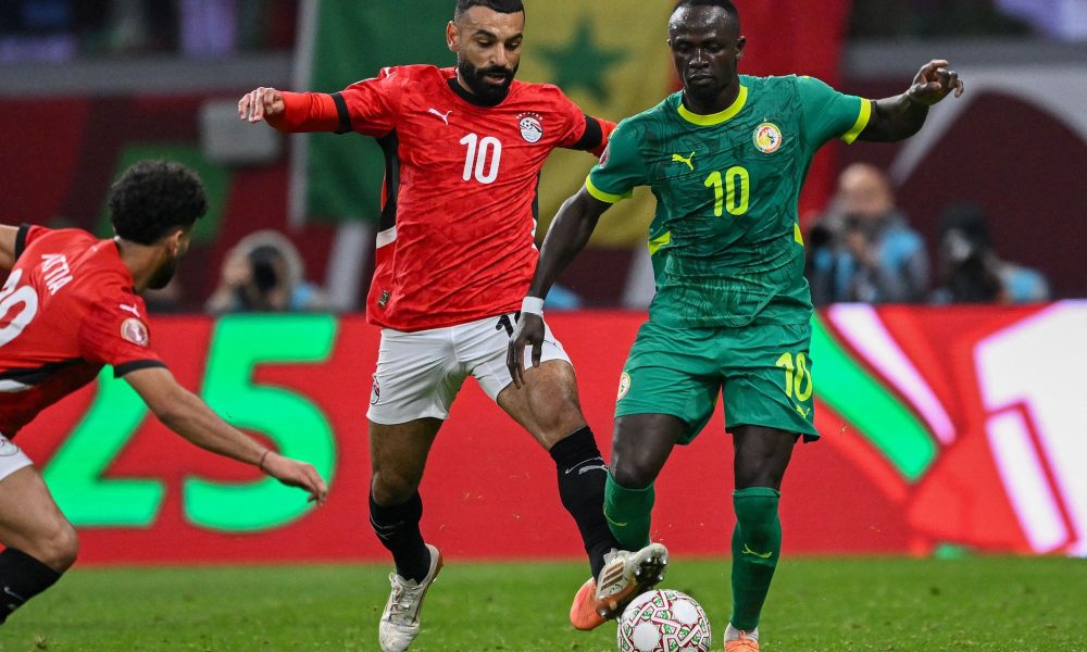 Mohamed Salah (left, wearing jersey number 10 for Egypt) and Sadio Mané (right, wearing jersey number 10 for Senegal) competing during the 2025 Africa Cup of Nations (AFCON) semi-final match. Image used for Sportxparte news.
