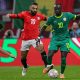 Mohamed Salah (left, wearing jersey number 10 for Egypt) and Sadio Mané (right, wearing jersey number 10 for Senegal) competing during the 2025 Africa Cup of Nations (AFCON) semi-final match. Image used for Sportxparte news.