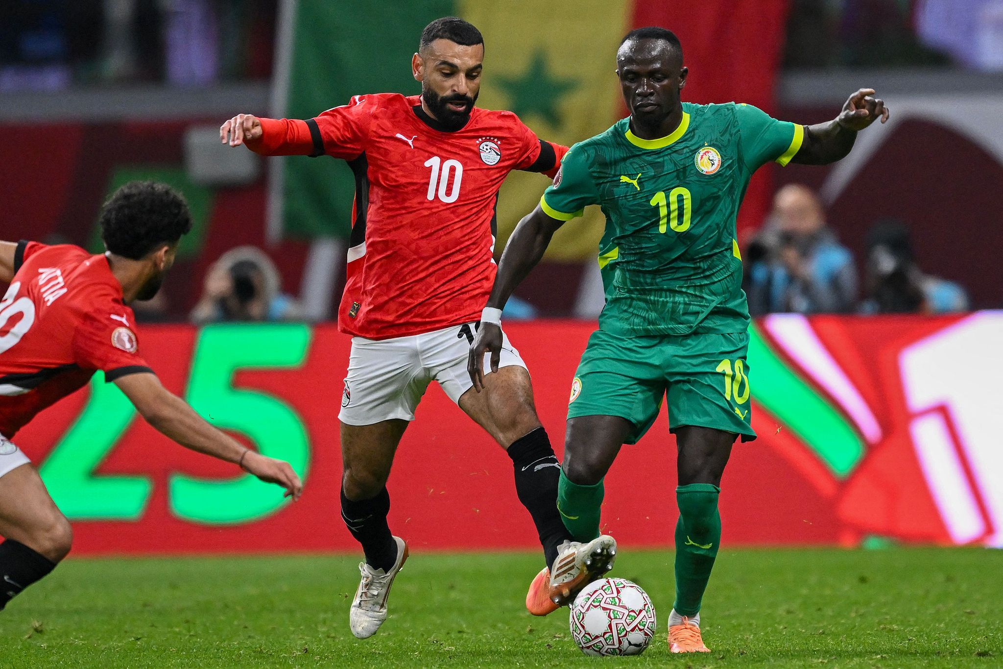 Mohamed Salah (left, wearing jersey number 10 for Egypt) and Sadio Mané (right, wearing jersey number 10 for Senegal) competing during the 2025 Africa Cup of Nations (AFCON) semi-final match. Image used for Sportxparte news.