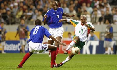 Senegal's El Hadji Diouf driving the ball past France's Patrick Vieira (No. 4) and Marcel Desailly (No. 8) during the opening match of the 2002 FIFA World Cup. Image used for Sportxparte news.