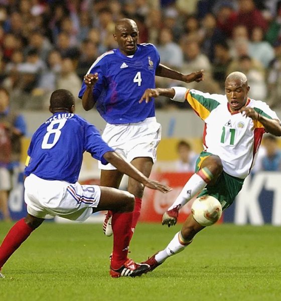 Senegal's El Hadji Diouf driving the ball past France's Patrick Vieira (No. 4) and Marcel Desailly (No. 8) during the opening match of the 2002 FIFA World Cup. Image used for Sportxparte news.